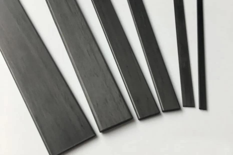 Various widths and thicknesses of high-strength pultruded carbon fiber strips with unidirectional fiber alignment for construction and drone spars.