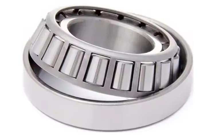 High-precision chrome steel tapered roller bearing designed to support combined radial and axial loads in heavy industrial machinery, featuring super-finished conical rollers and raceways for long service life.