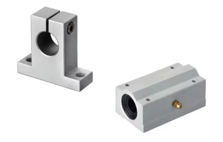 Industrial linear motion set featuring an SK series aluminum vertical shaft support (left) and an SCS series linear ball bearing slide unit (right) with integrated grease nipple for CNC and automation machinery.